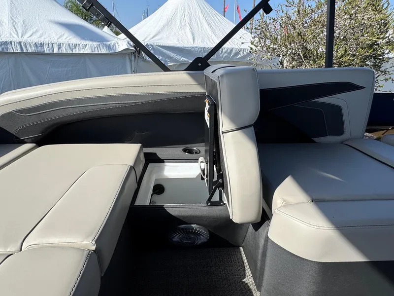 Slide: The Image of 2026 Barletta Cabrio 24U boat interior with beige seating and storage compartment. - 40