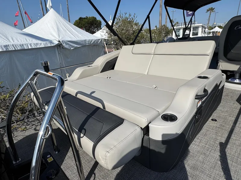 Slide: The Image of 2026 Barletta Cabrio 24U boat with luxurious seating and cup holders, displayed outdoors. - 43