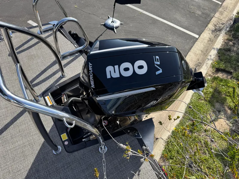 Slide: The Image of 2026 Barletta Cabrio 24U with Mercury 200 V6 engine, parked on pavement. - 48