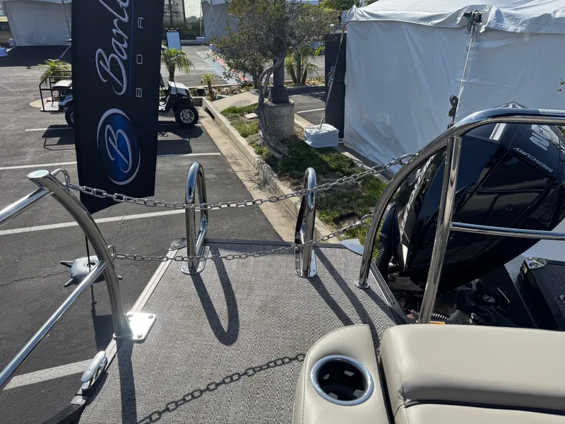 Slide: The Image of 2026 Barletta Cabrio 24U boat with Mercury engine, displayed outdoors near tents. - 49