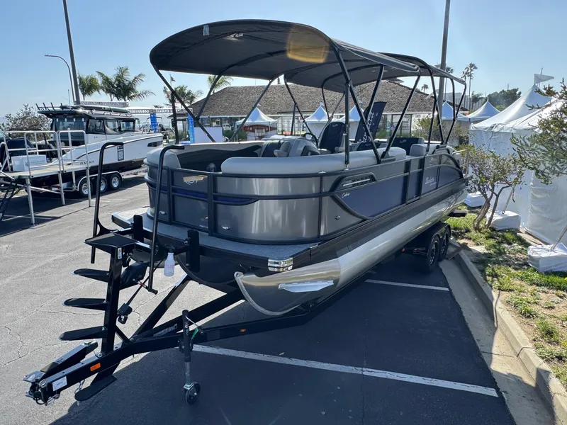 Slide: The Image of 2026 Barletta Cabrio 24U pontoon boat on trailer, parked outdoors. - 5