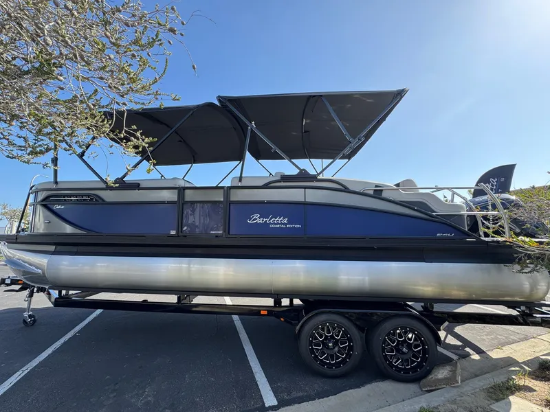Slide: The Image of 2026 Barletta Cabrio 24U pontoon boat on trailer under clear blue sky. - 6