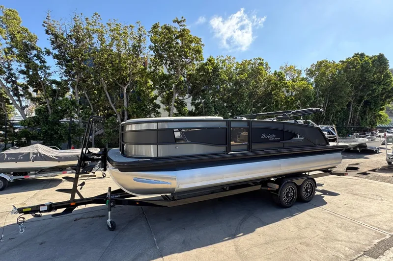 Slide: The Image of 2026 Barletta Lusso 23UC pontoon boat on trailer, parked outdoors. - 119