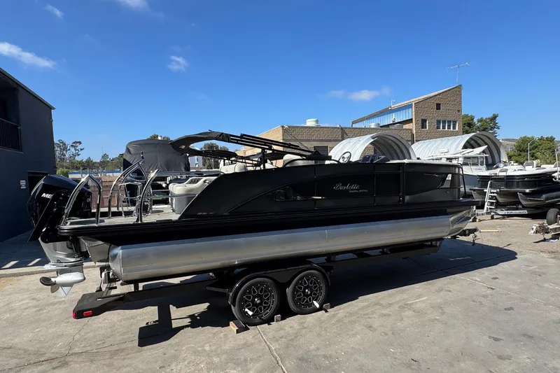Slide: The Image of 2026 Barletta Lusso 23UC pontoon boat on trailer, parked outdoors. - 127