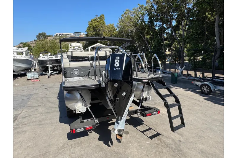 Slide: The Image of 2026 Barletta Lusso 23UC pontoon boat with powerful 300 V8 engine, docked outdoors. - 130