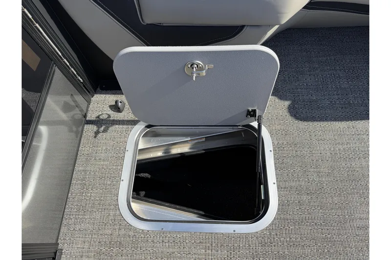 Slide: The Image of Open storage hatch on 2026 Barletta Lusso 23UC boat, featuring gray carpeted flooring. - 146