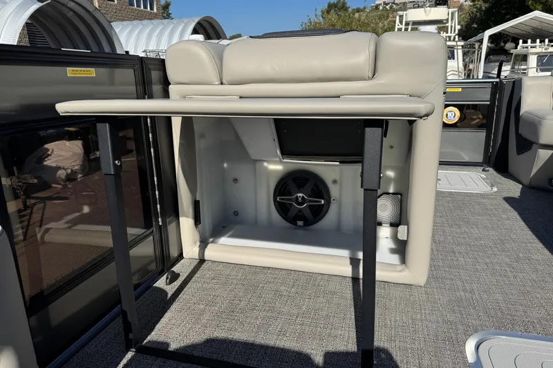 Slide: The Image of 2026 Barletta Lusso 23UC boat interior with storage compartment and speaker system. - 150