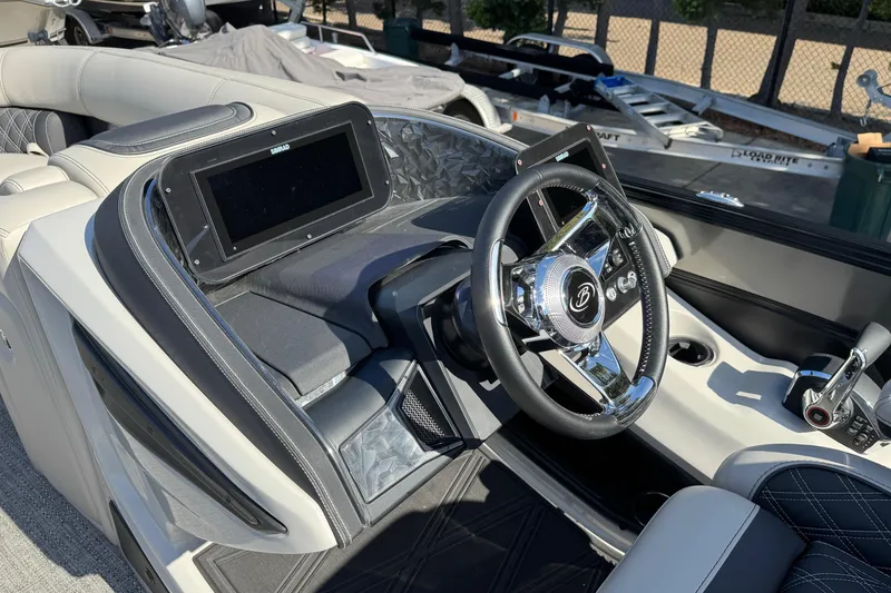 Slide: The Image of 2026 Barletta Lusso 23UC boat dashboard with steering wheel and navigation display. - 154