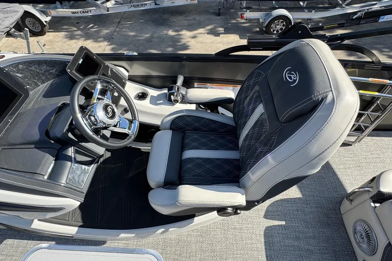 Slide: The Image of 2026 Barletta Lusso 23UC boat interior with luxurious captain's chair and modern steering console. - 155