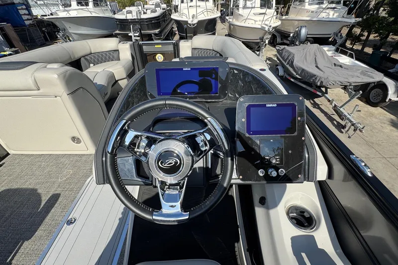 Slide: The Image of 2026 Barletta Lusso 23UC boat interior with steering wheel and navigation screens. - 156