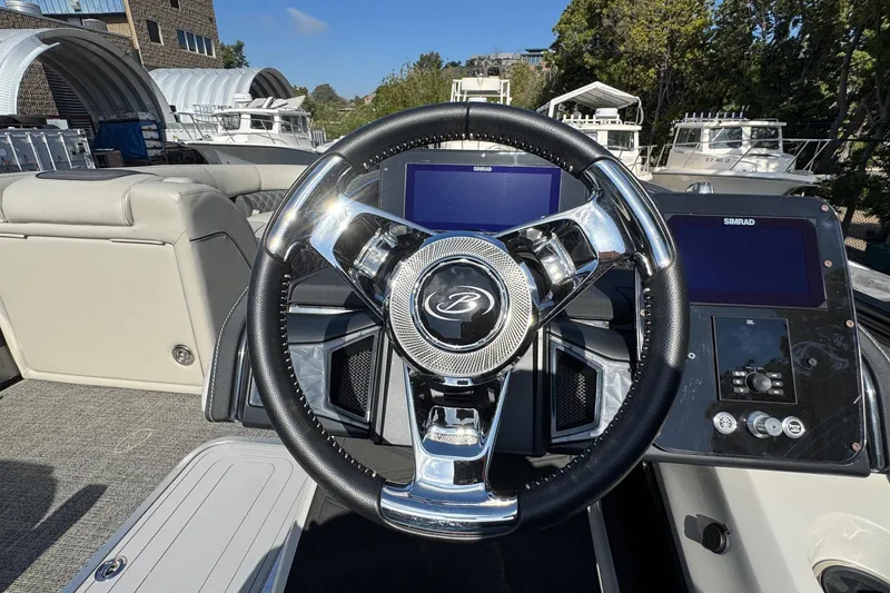 Slide: The Image of Steering wheel of 2026 Barletta Lusso 23UC boat with modern dashboard controls. - 157