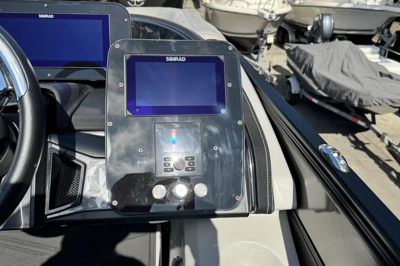 Slide: The Image of Control panel of 2026 Barletta Lusso 23UC boat with Simrad display screens. - 158