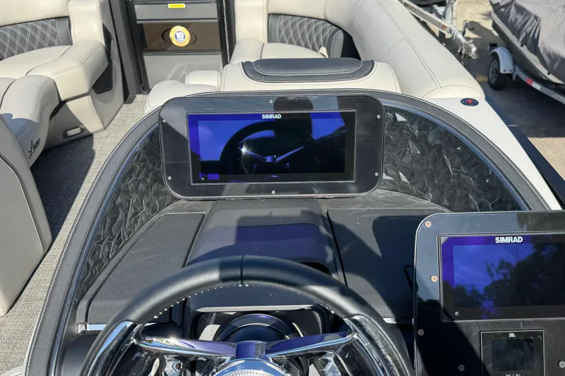 Slide: The Image of 2026 Barletta Lusso 23UC boat dashboard with Simrad displays and luxurious seating. - 159