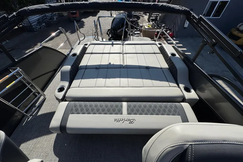 Slide: The Image of 2026 Barletta Lusso 23UC boat interior with luxurious seating and cup holders. - 168