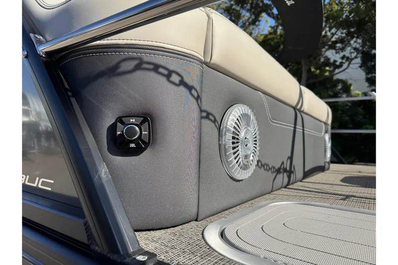 Slide: The Image of 2026 Barletta Lusso 23UC boat interior with JBL speaker and cushioned seating. - 174