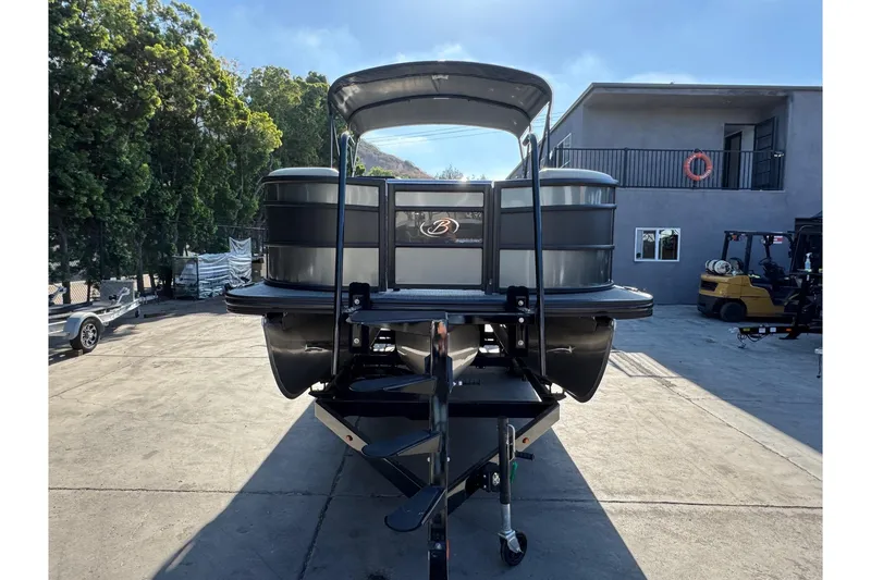 Slide: The Image of 2026 Barletta Lusso 23UC pontoon boat on trailer, parked outdoors. - 182