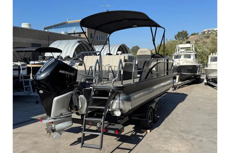 Slide: The Image of 2026 Barletta Lusso 23UC pontoon boat with Mercury engine, parked on a trailer. - 187