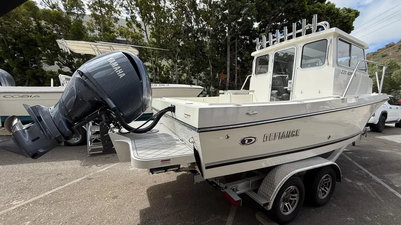 Slide: The Image of 2025 Defiance Admiral 220 EX boat with Yamaha outboard motor on a trailer. - 10