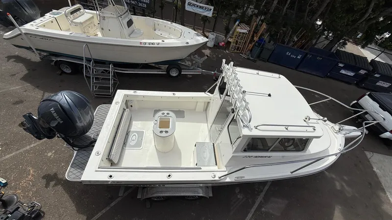 Slide: The Image of 2025 Defiance Admiral 220 EX boat on trailer, featuring spacious deck and Yamaha outboard motor. - 12