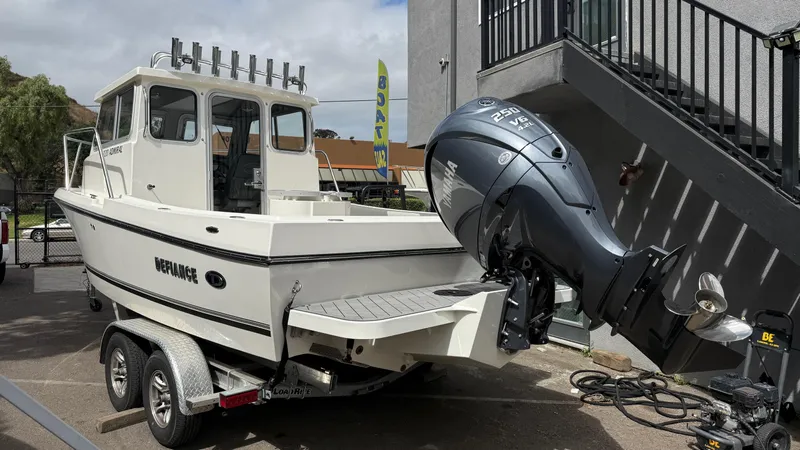 Slide: The Image of 2025 Defiance Admiral 220 EX boat with Yamaha 250 V6 engine on trailer. - 14