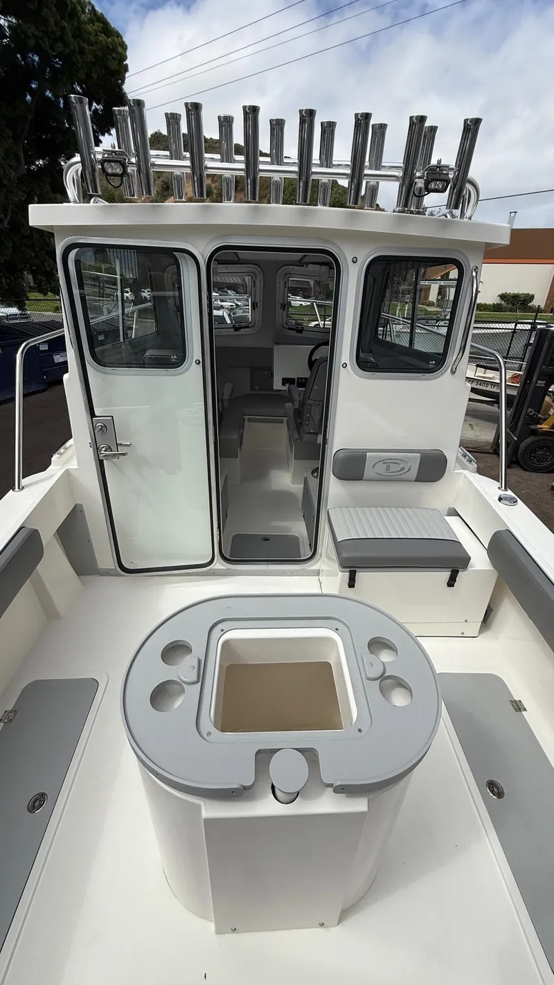 Slide: The Image of 2025 Defiance Admiral 220 EX boat interior with seating and rod holders. - 18