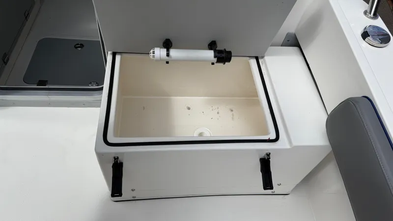 Slide: The Image of Open storage compartment on 2025 Defiance Admiral 220 EX boat, featuring a clean, spacious interior. - 24