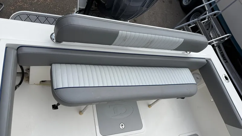 Slide: The Image of 2025 Defiance Admiral 220 EX boat seating area with gray and white cushioned seats. - 26