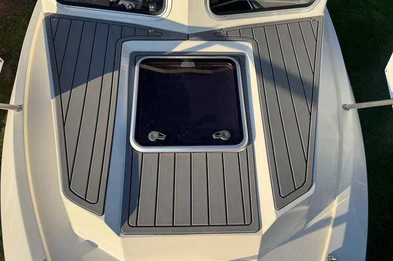 Slide: The Image of Bow deck of 2025 Defiance Admiral 250 EX with sleek gray non-slip surface. - 100