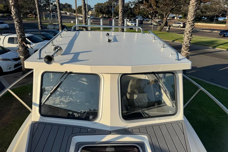 Slide: The Image of 2025 Defiance Admiral 250 EX boat with sleek cabin design and rooftop details. - 101