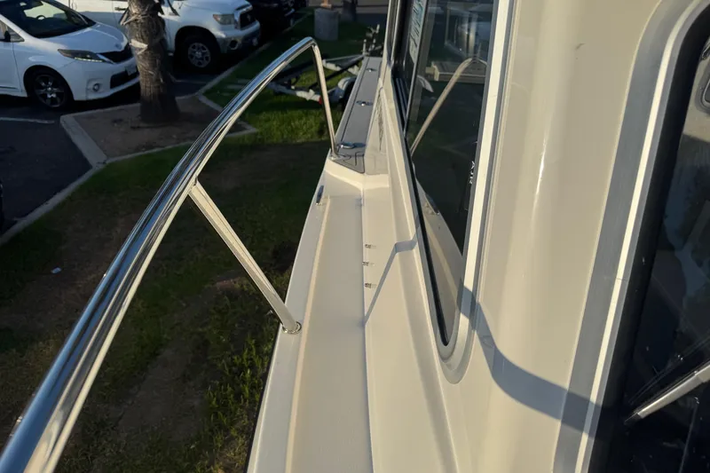 Slide: The Image of 2025 Defiance Admiral 250 EX boat with sleek railing and window detail. - 103