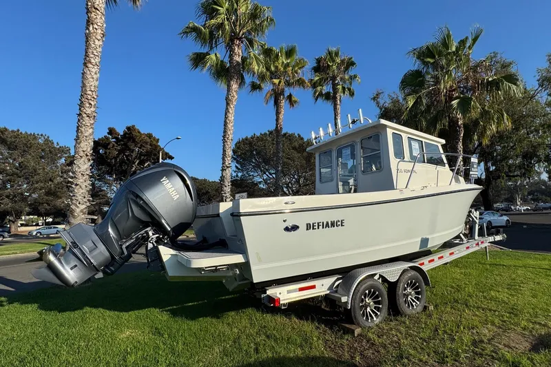 Slide: The Image of 2025 Defiance Admiral 250 EX boat on trailer, parked near palm trees. - 17