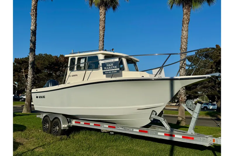 Slide: The Image of 2025 Defiance Admiral 250 EX boat on trailer, displayed outdoors with palm trees. - 3