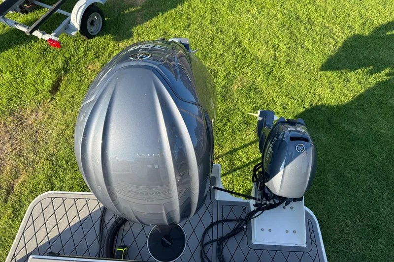 Slide: The Image of Top view of 2025 Defiance Admiral 250 EX boat engines on grass. - 30