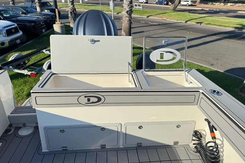 Slide: The Image of 2025 Defiance Admiral 250 EX boat deck with storage compartments and logo. - 34