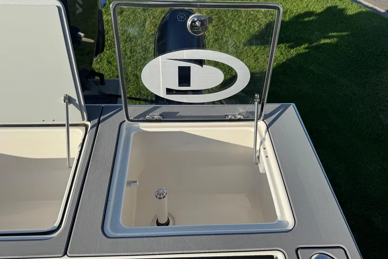 Slide: The Image of Open storage compartment on 2025 Defiance Admiral 250 EX boat, featuring a transparent lid. - 36