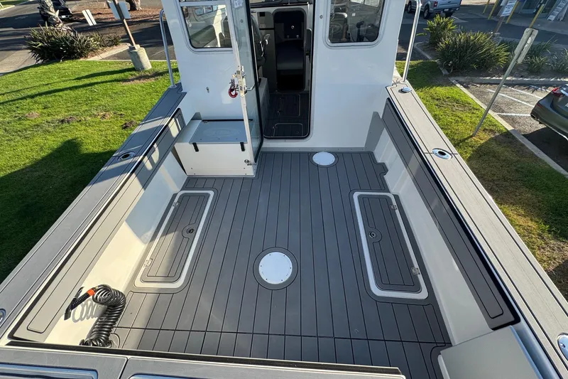 Slide: The Image of 2025 Defiance Admiral 250 EX boat deck with storage compartments and seating. - 38