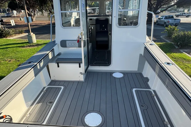 Slide: The Image of 2025 Defiance Admiral 250 EX boat interior with spacious deck and seating. - 40