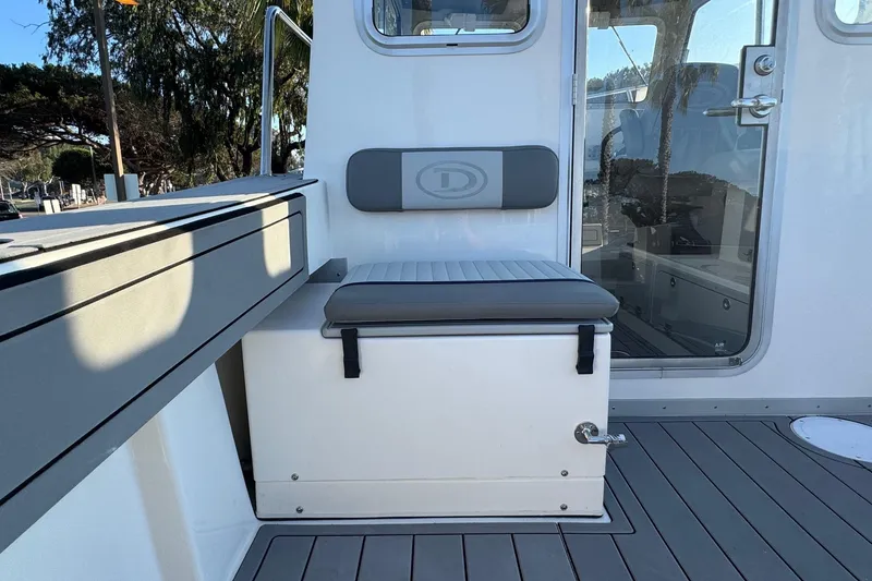 Slide: The Image of 2025 Defiance Admiral 250 EX boat interior with cushioned seating and sleek design. - 42