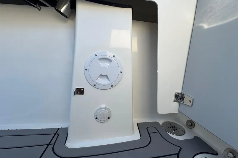 Slide: The Image of Interior view of 2025 Defiance Admiral 250 EX boat, featuring storage compartment and deck details. - 46