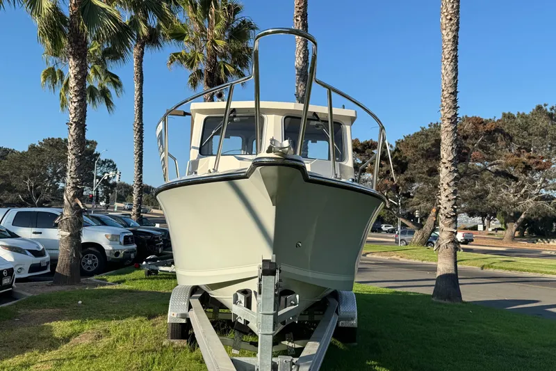 Slide: The Image of 2025 Defiance Admiral 250 EX boat on trailer, parked near palm trees. - 5
