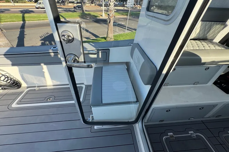 Slide: The Image of Interior view of 2025 Defiance Admiral 250 EX boat with seating and storage. - 53