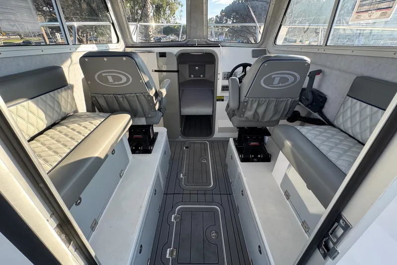 Slide: The Image of Interior of 2025 Defiance Admiral 250 EX boat with seating and steering area. - 54