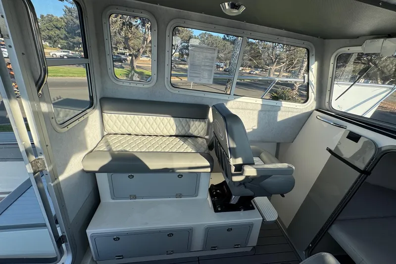 Slide: The Image of Interior of 2025 Defiance Admiral 250 EX boat with seating and windows. - 55