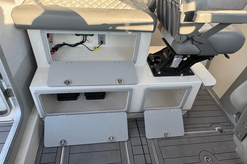 Slide: The Image of Interior of 2025 Defiance Admiral 250 EX boat showing storage compartments and seating. - 57