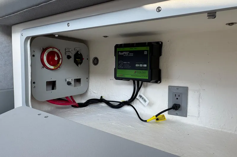 Slide: The Image of Electrical panel and battery charger inside 2025 Defiance Admiral 250 EX boat. - 58