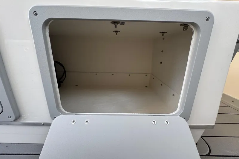 Slide: The Image of Open storage compartment on 2025 Defiance Admiral 250 EX boat. - 62