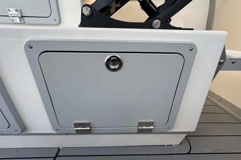 Slide: The Image of Storage compartment on 2025 Defiance Admiral 250 EX boat, featuring a secure latch and hinges. - 63