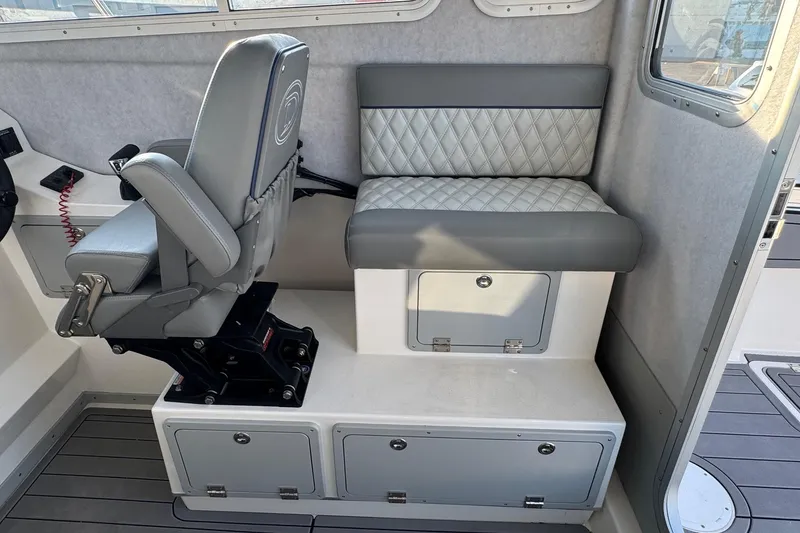 Slide: The Image of Interior of 2025 Defiance Admiral 250 EX boat with seating and storage compartments. - 64