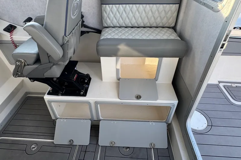 Slide: The Image of Interior of 2025 Defiance Admiral 250 EX boat with seating and storage compartments. - 65