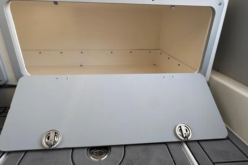 Slide: The Image of Open storage compartment on 2025 Defiance Admiral 250 EX boat. - 68